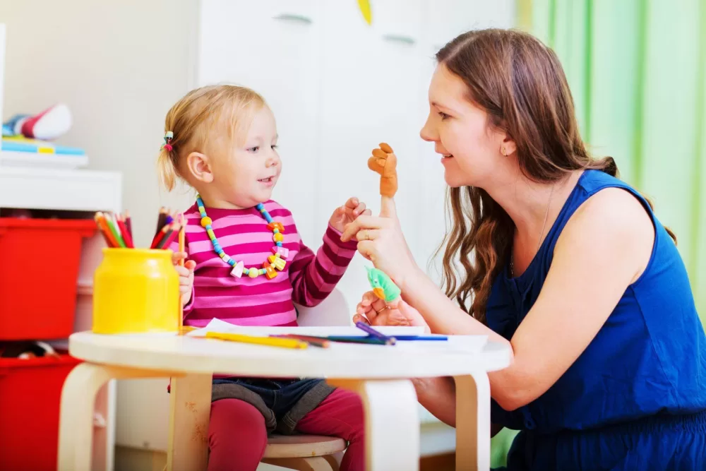 Carer and child at table scaled 1920x0 c default